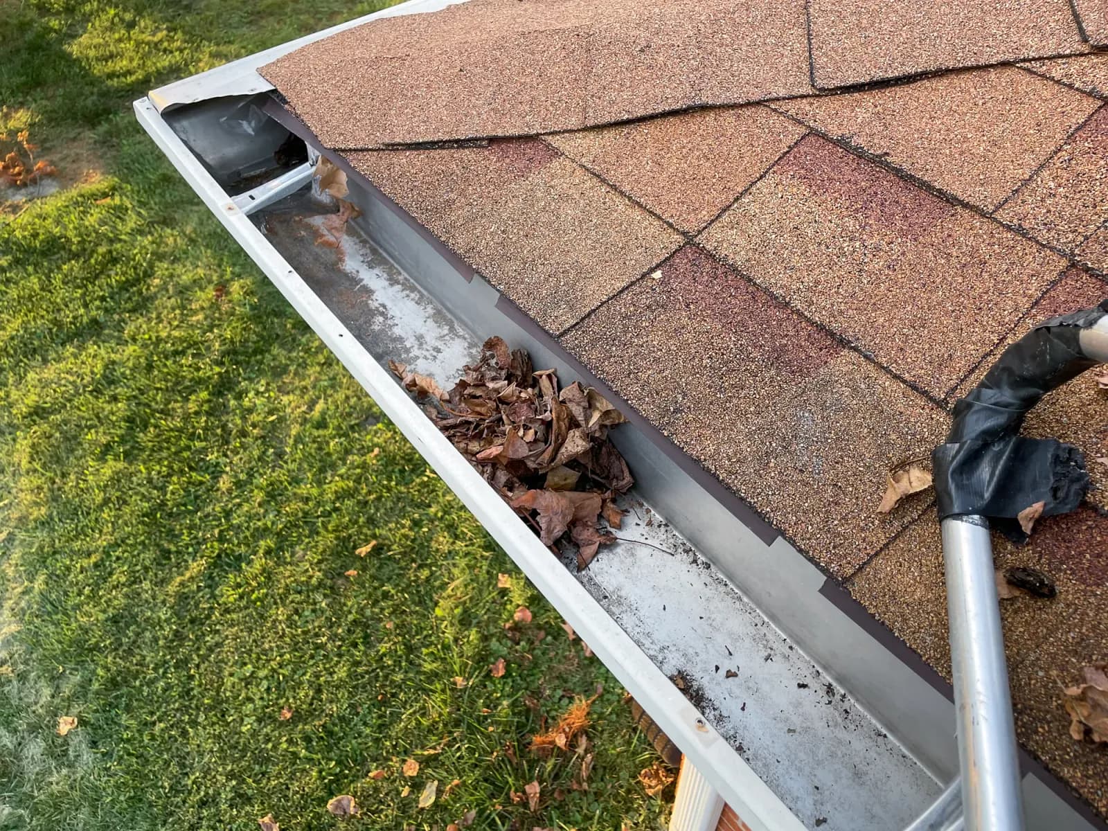 Barely clogged downspout opening causing backup