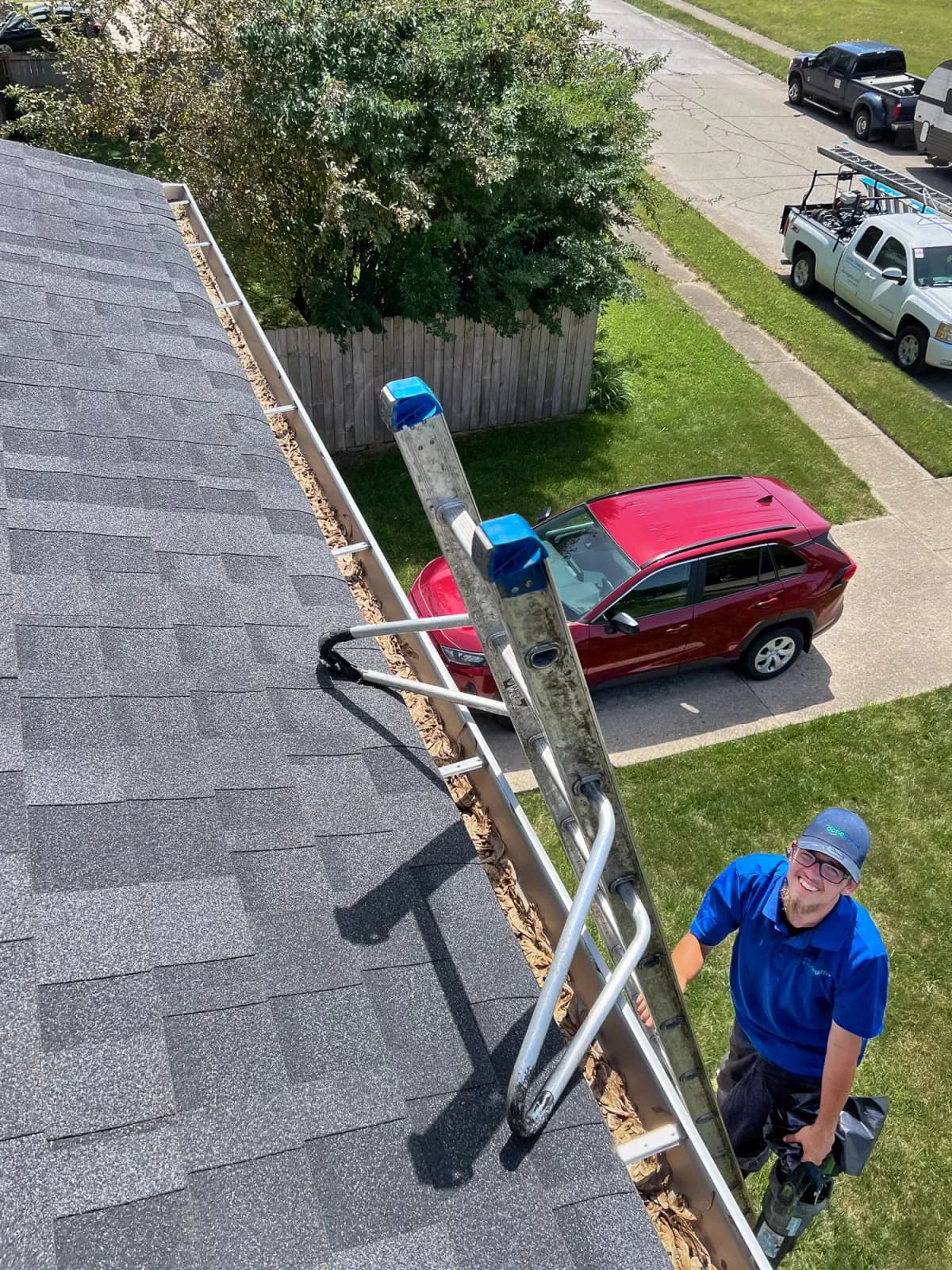Clayton on a ladder during a gutter cleaning job
