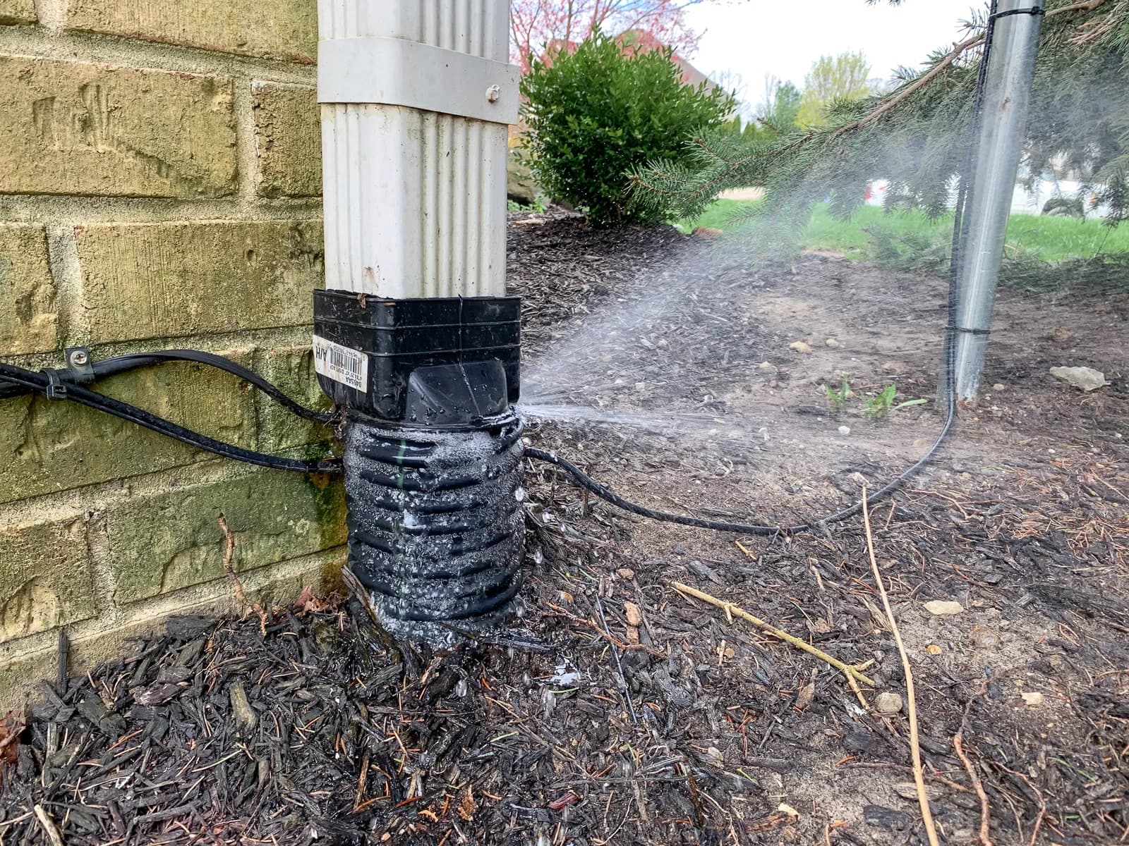 Jetting in progress on corrugated downspout extension